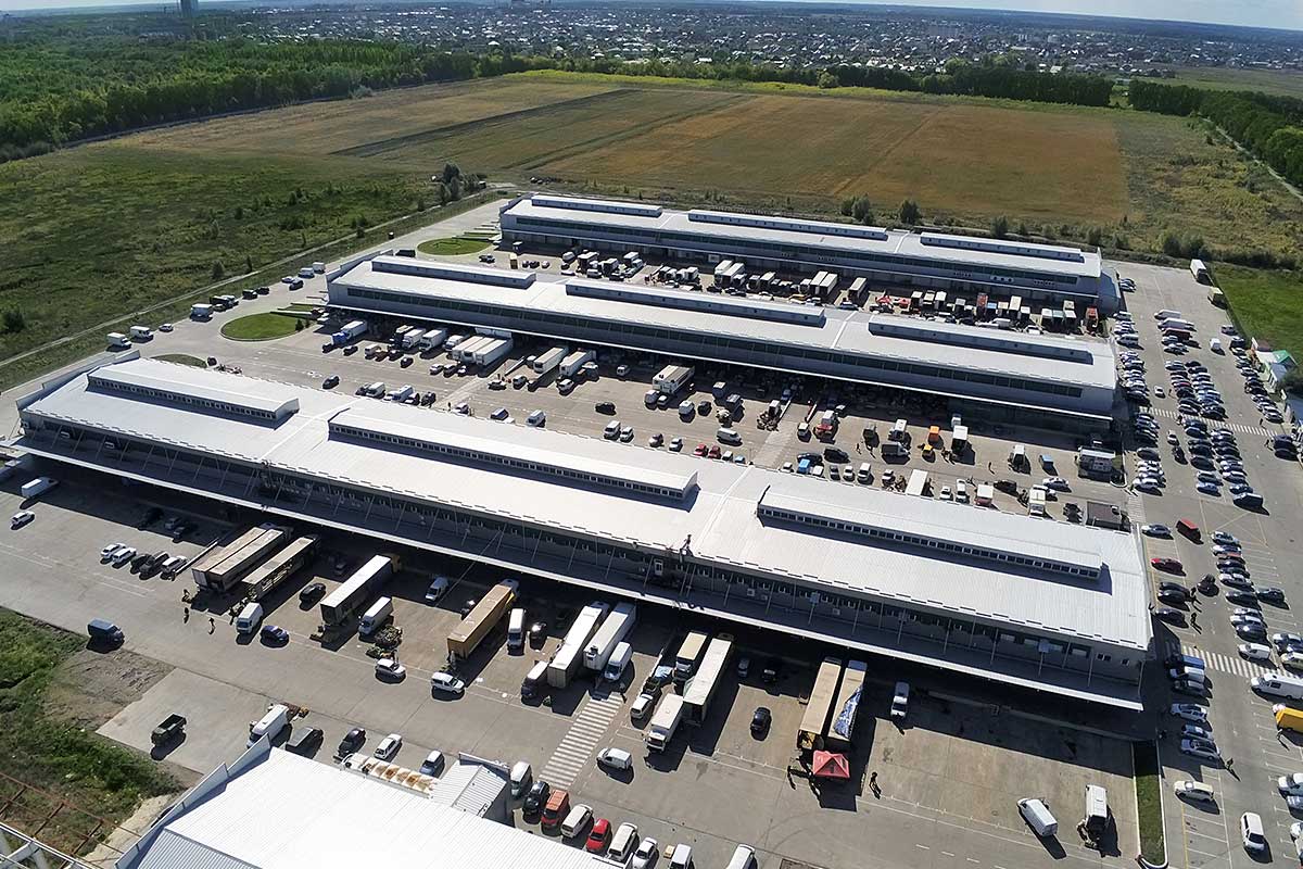 Aerial-drone-view-of-group-of-large-modern-industrial-warehouse-or-factory-buildings-in-suburban