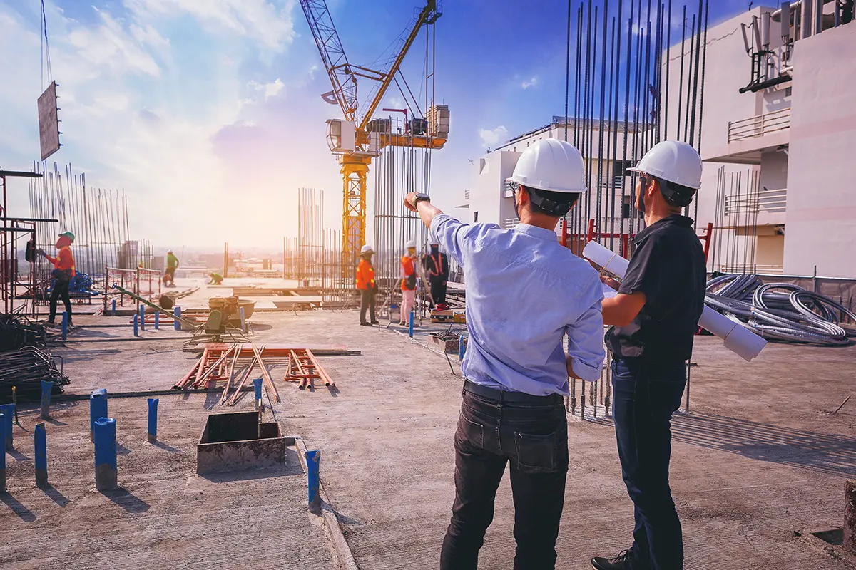 Smart civil architect engineer inspecting and working outdoors structure building site